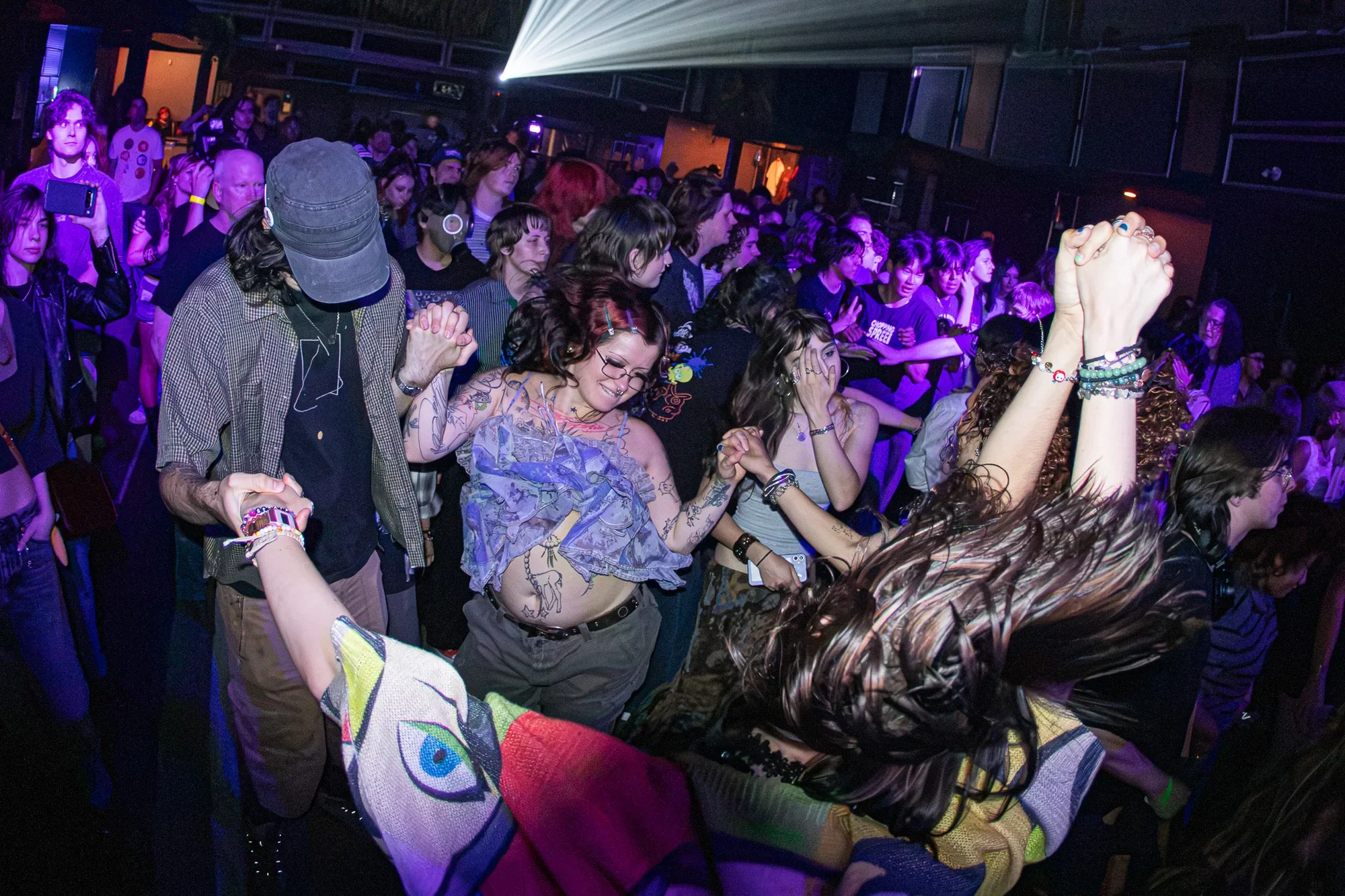 People moshing and dancing in the crowd